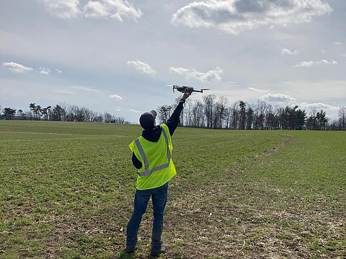Person with drone in farm field