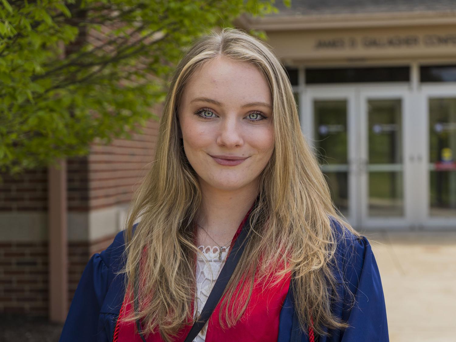 Female student wearing blue commencement regalia