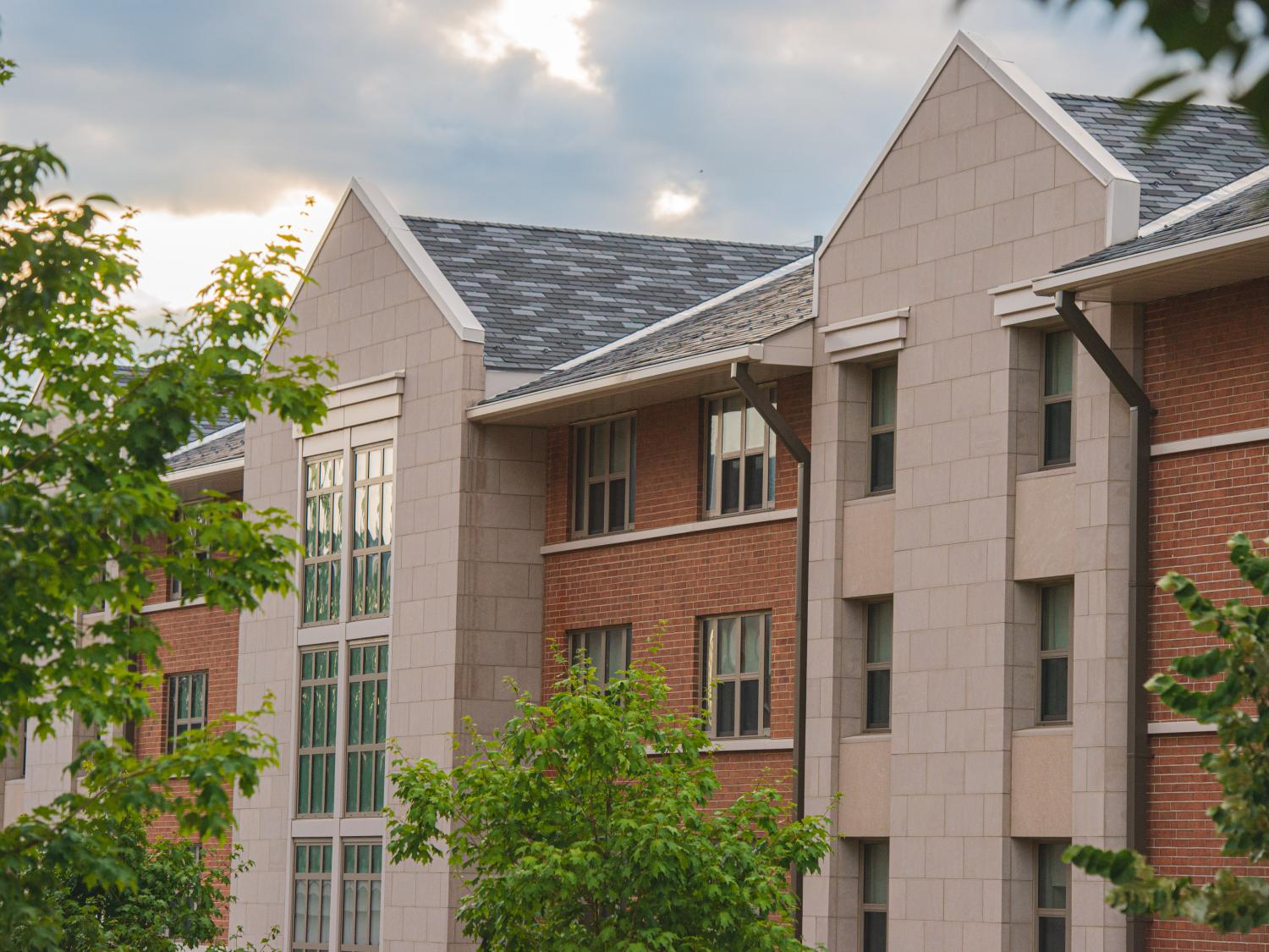 A residence hall surrounded by green trees