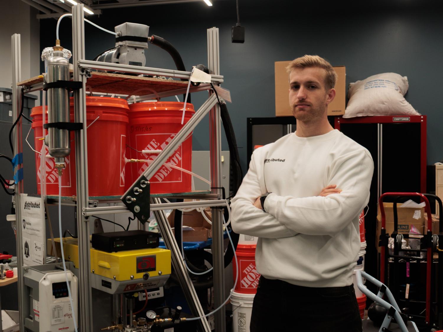 Matthew Hollingham poses next to his carbon capture system