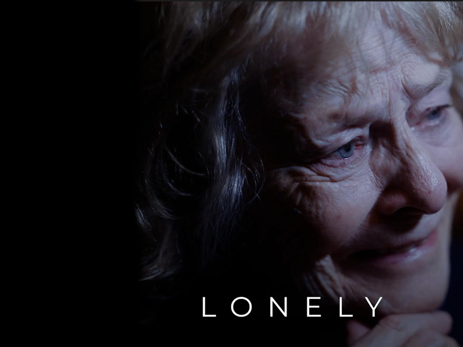 An older woman's face, with the word LONELY at the bottom