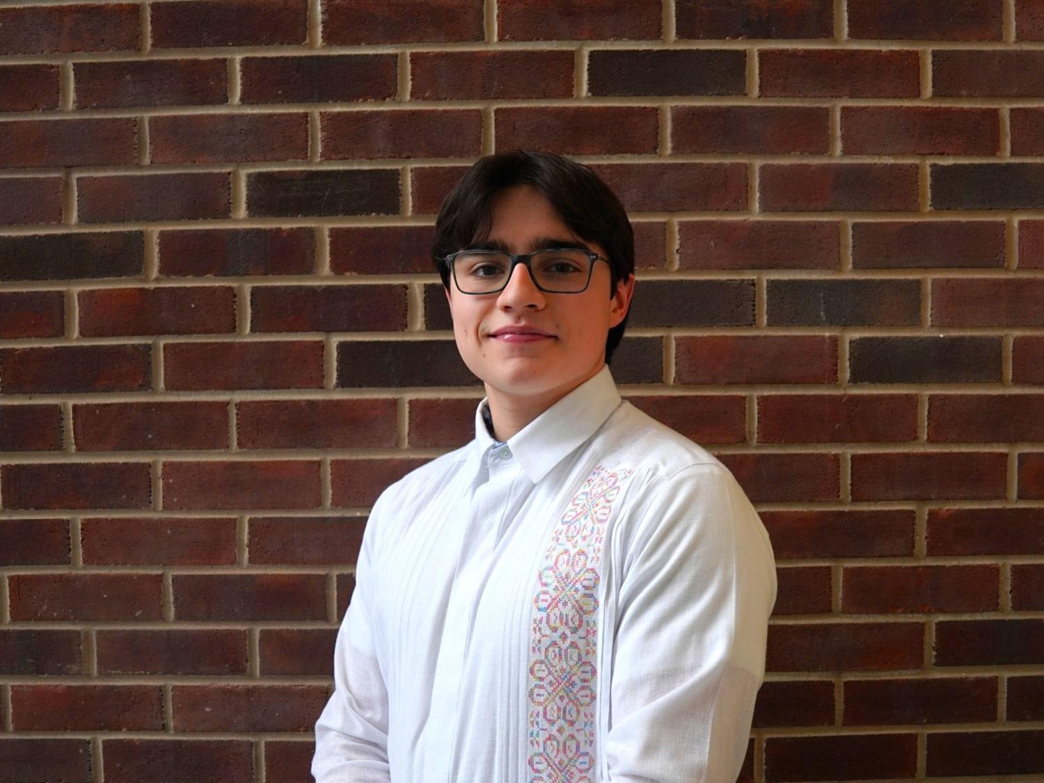Matias Moreno posing in front of brick wall