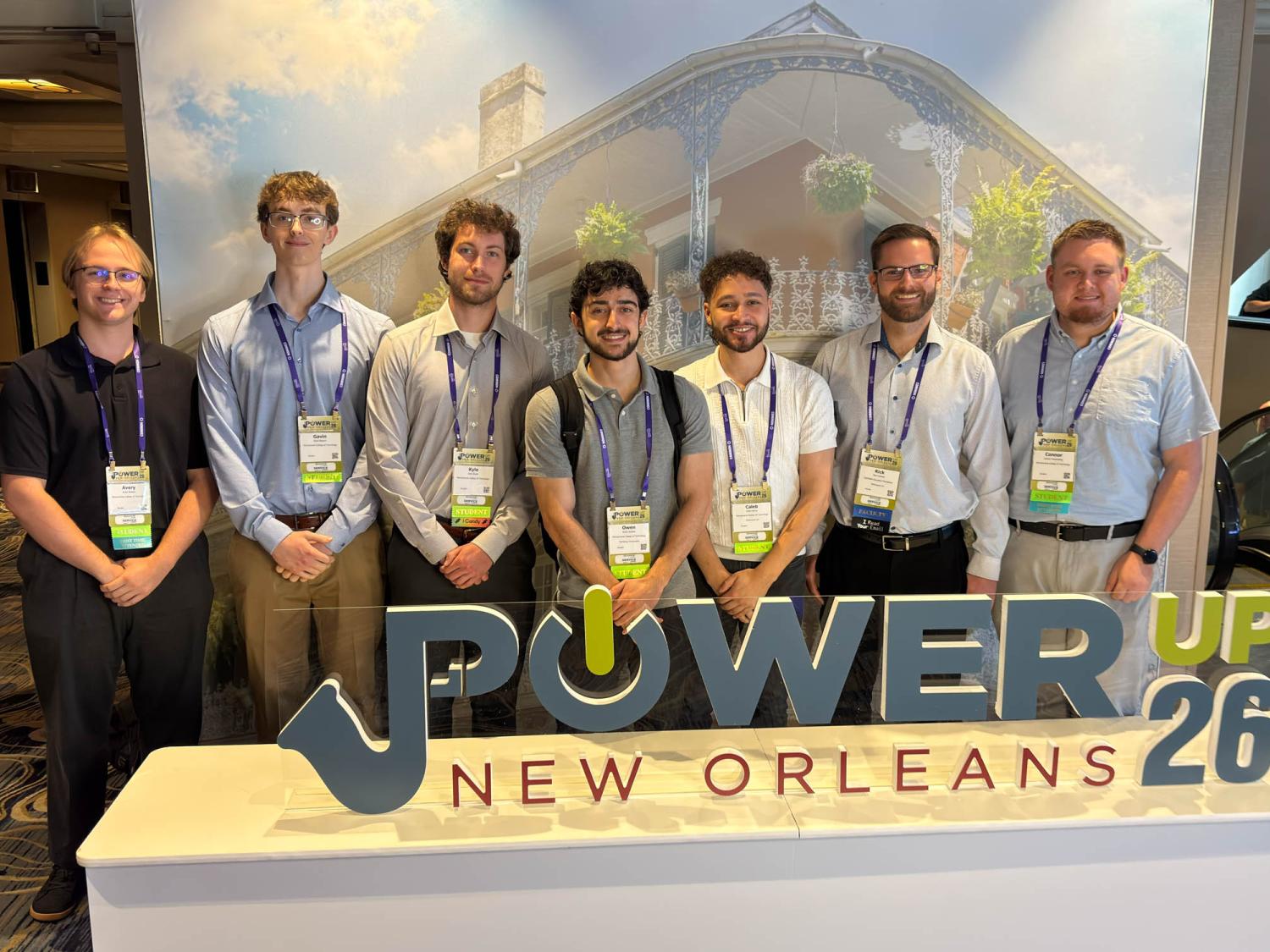 A group of seven students post for a photo
