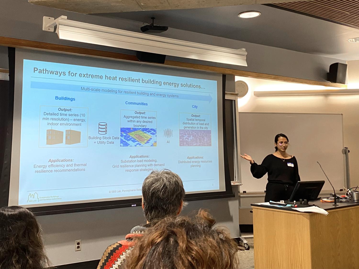 Rosina Adhikari presenting her research in front of a classroom