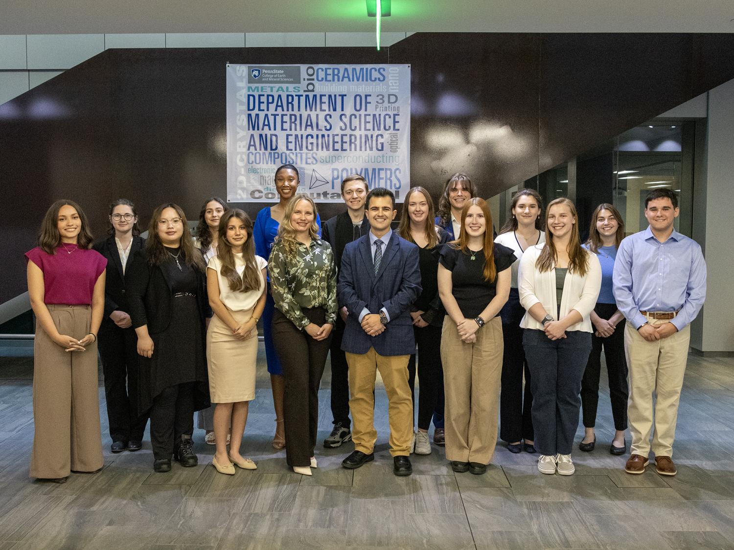 Sixteen students in professional attire