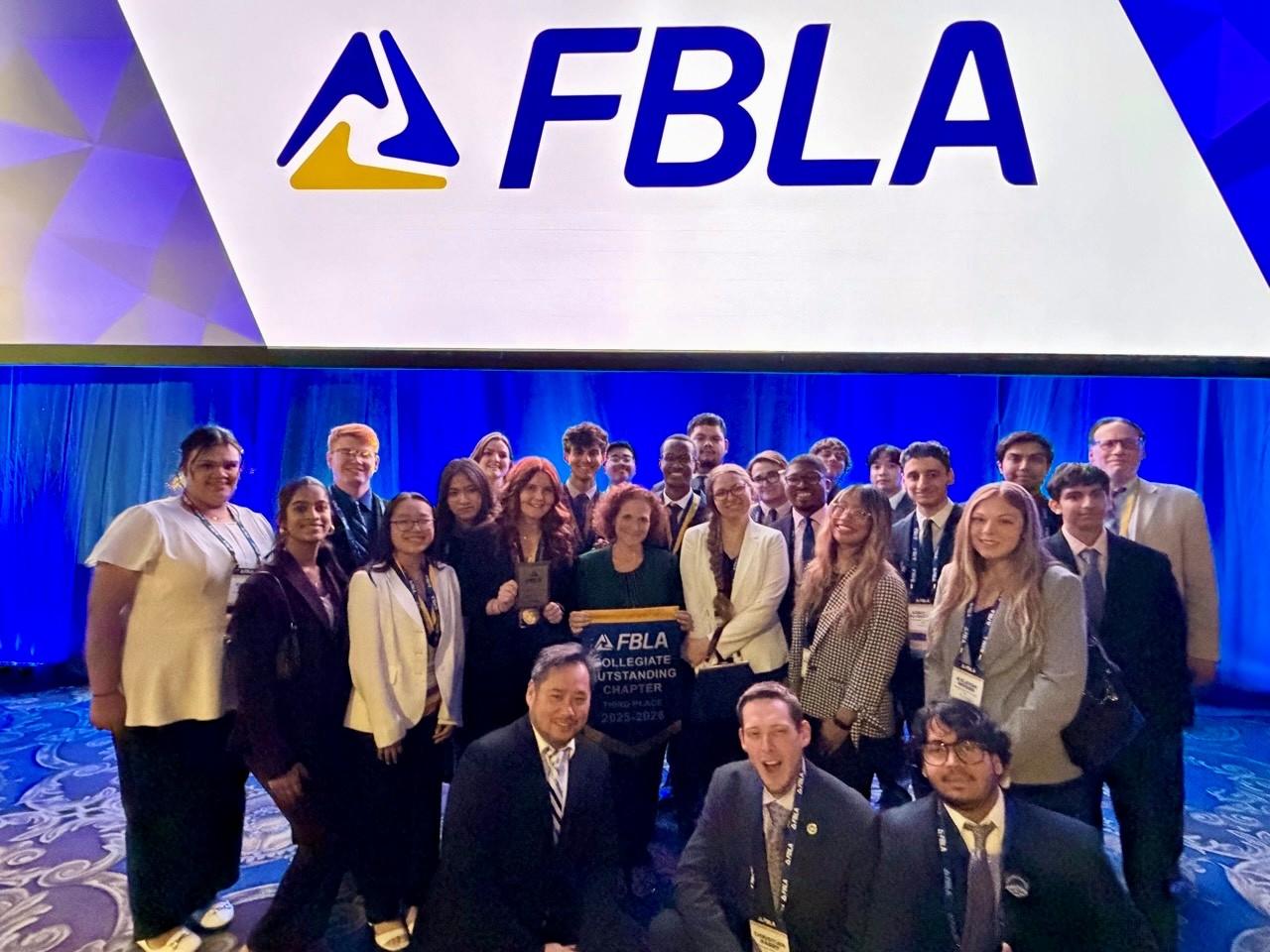 A group picture of students and advisors posing for a picture