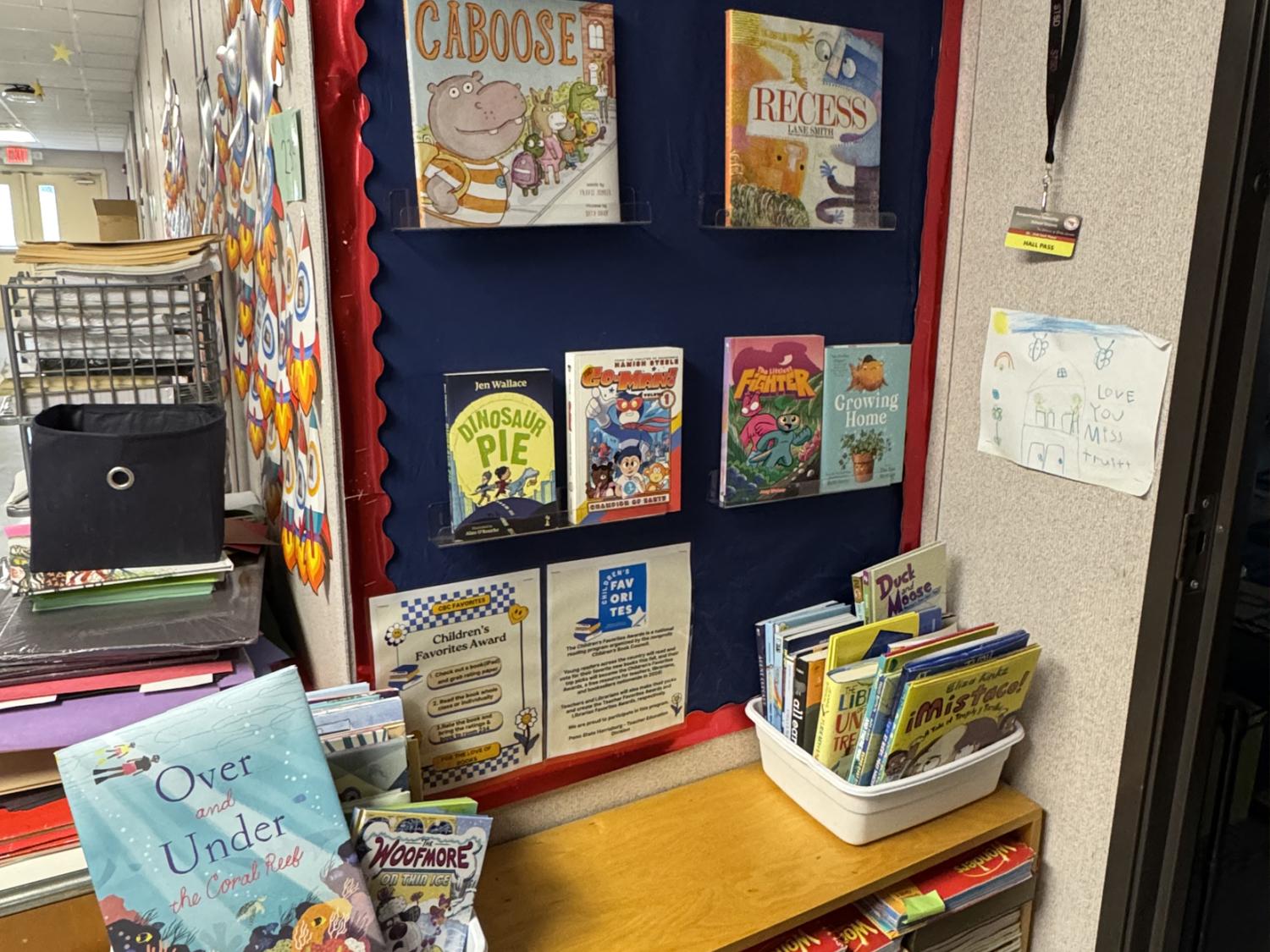A classroom display of books on a wall, with instructions for how to vote for favorites below