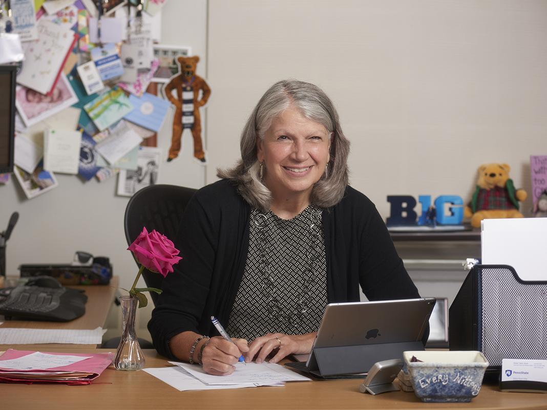 Mitch Kirsch sits at her desk with her laptop