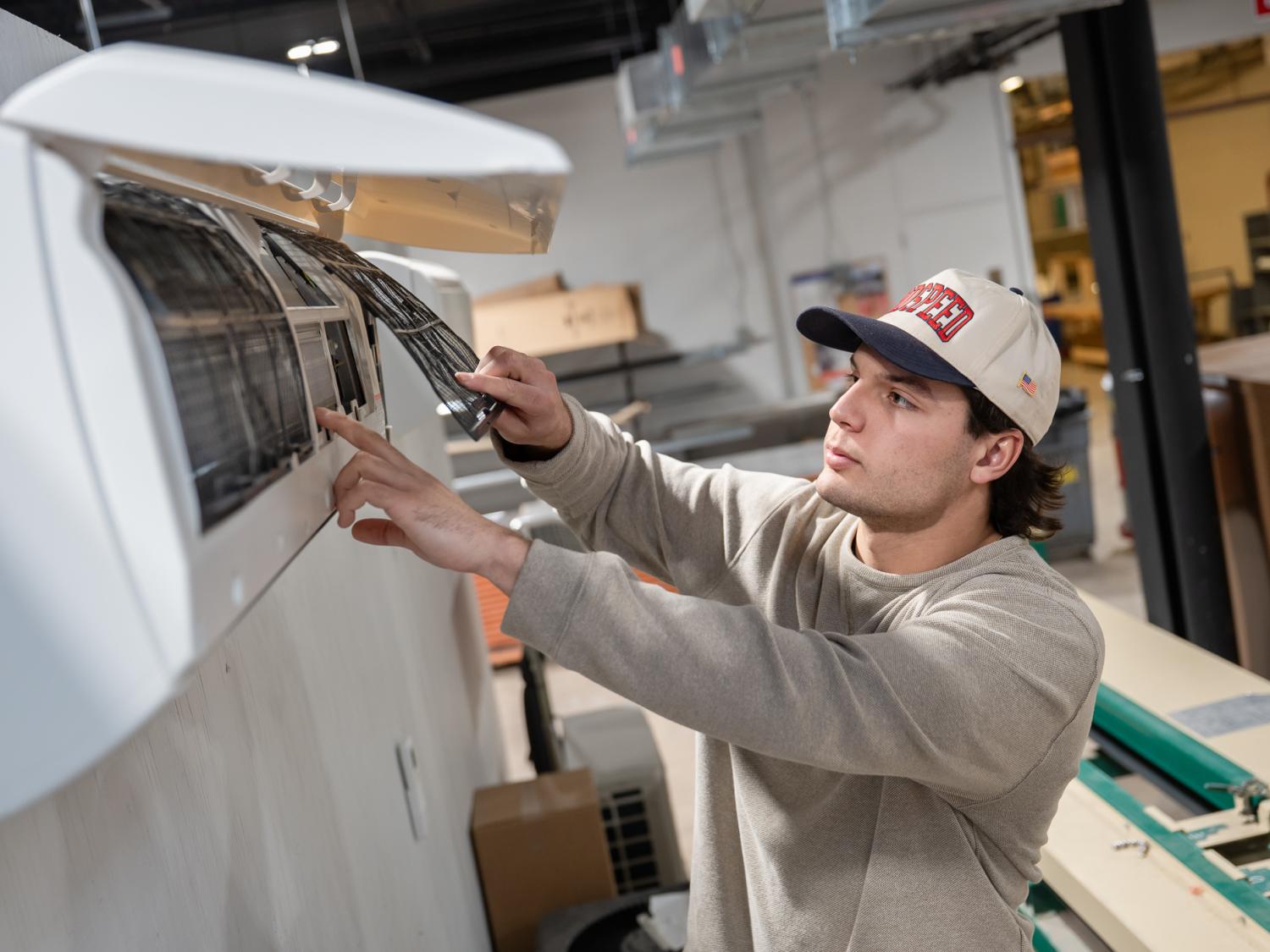 Marcello A. Santora services a mini-split indoor unit 