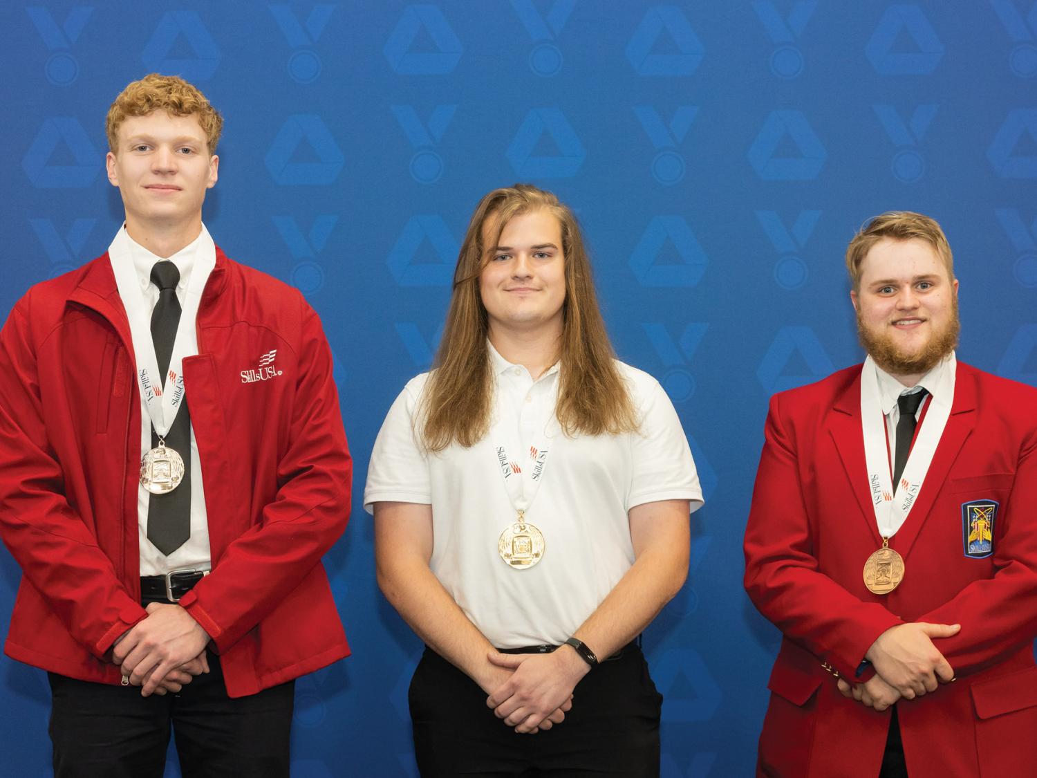 Three people pose for a photo