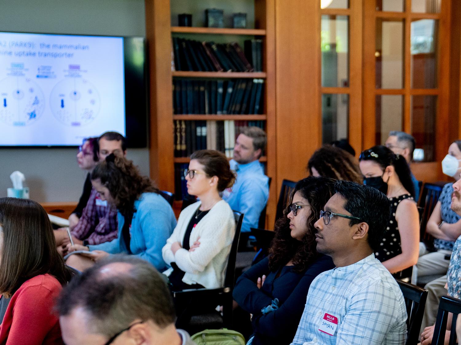 Audience members watching a speaker at the 2023 Neuroscience Institute retreat