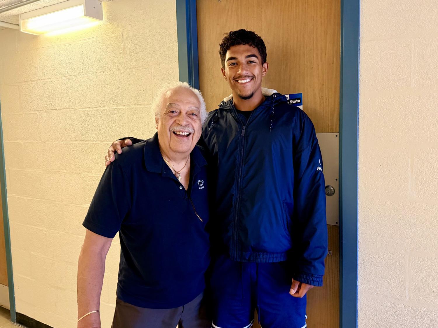 John Robinson, also known as "the Penn State Pop Pop," embraces his grandson Wes Robinson during move-in day at Beaver Hall on the University Park campus
