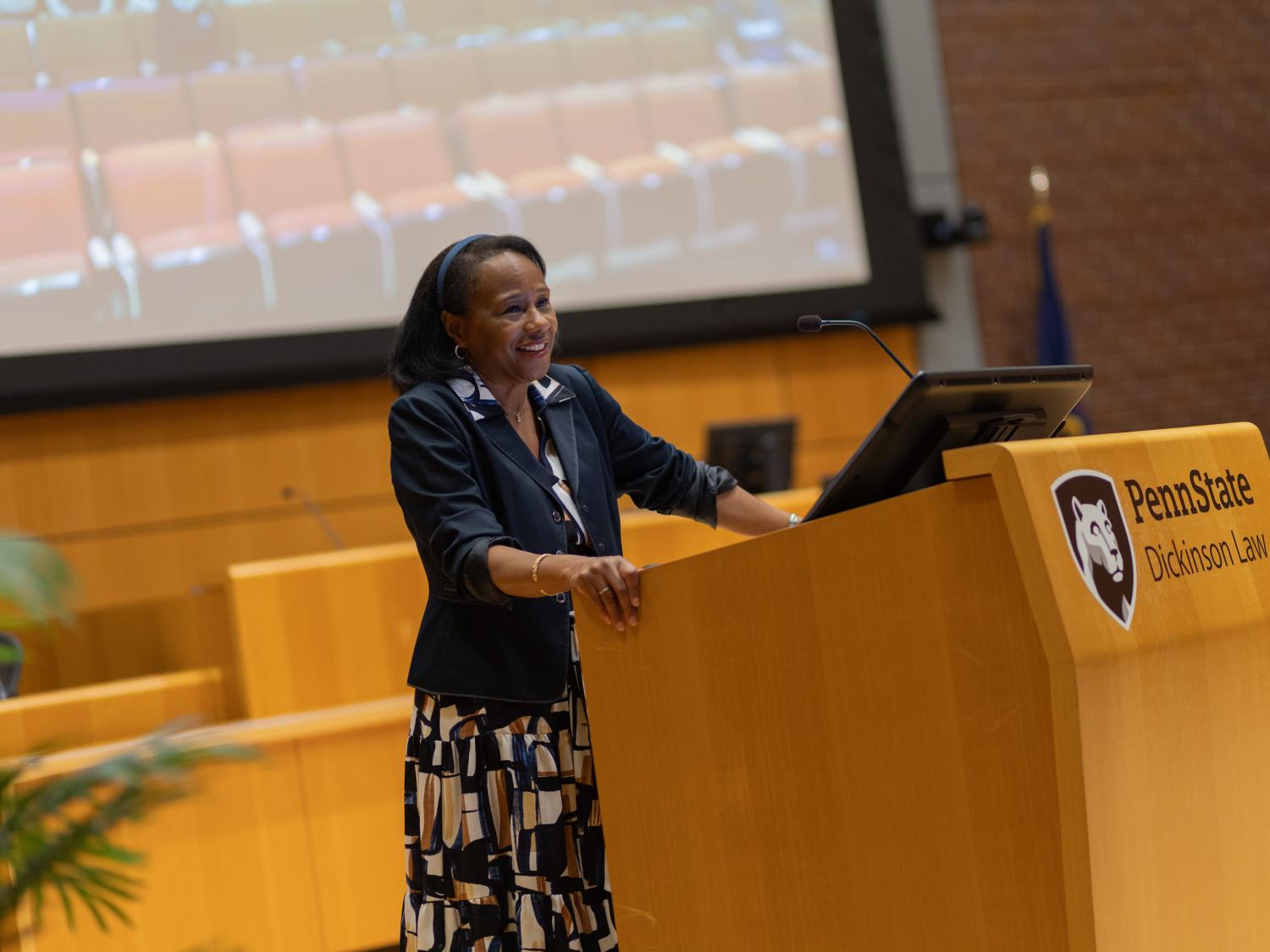Black woman standing at a podium