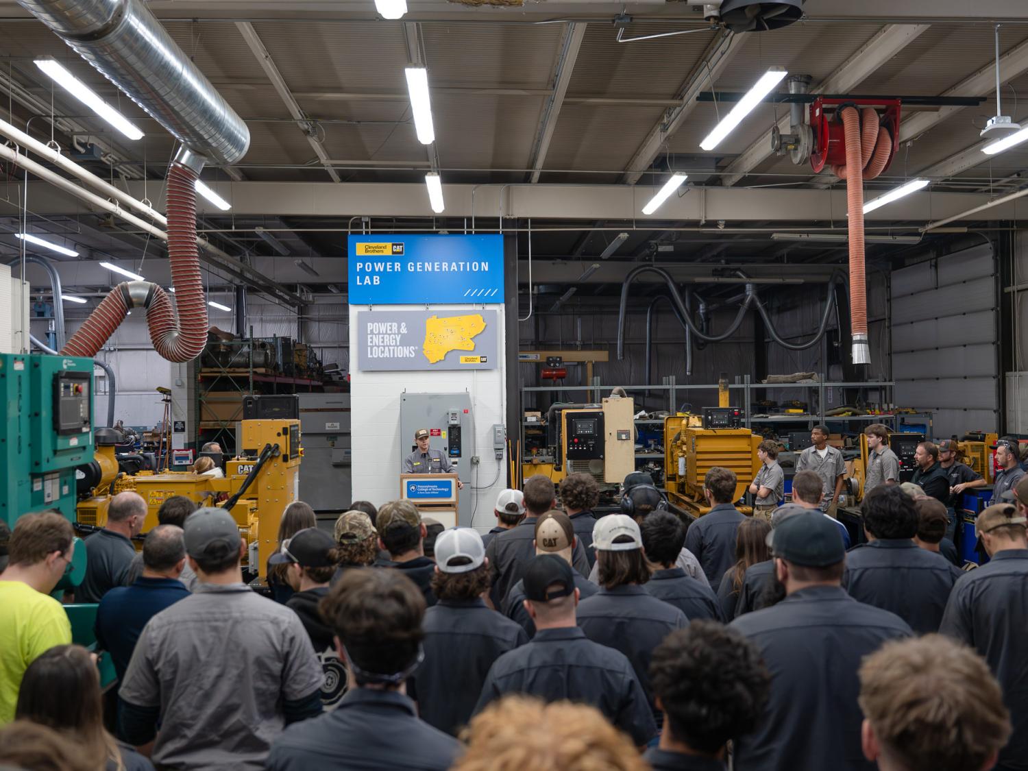 On-site power generation technology student Roman M. Moss, of Stillwater, speaks to onlookers during the dedication of the Cleveland Brothers Cat Power Generation Lab at Pennsylvania College of Technology. 