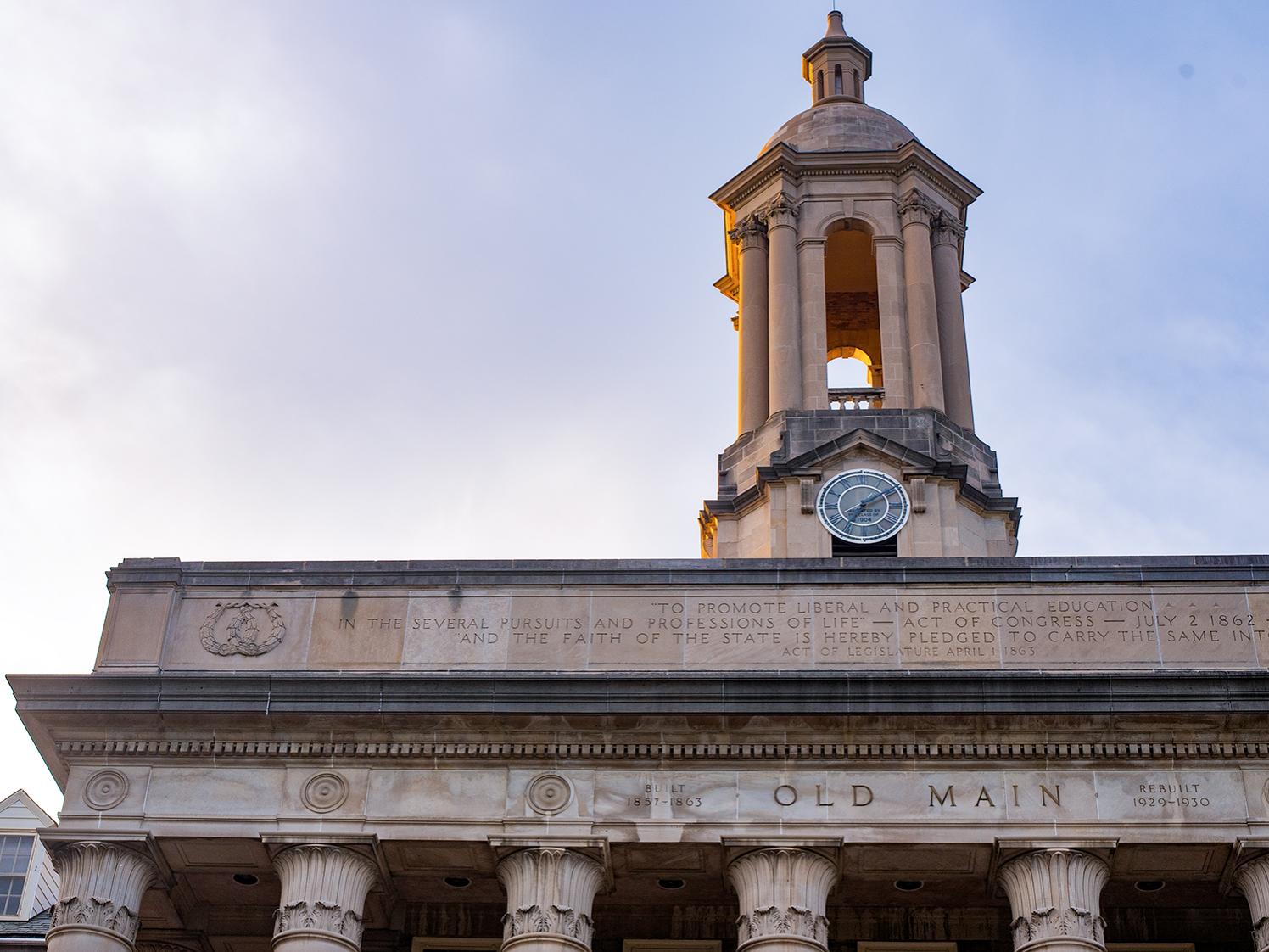 An image of Old Main's bell tower and the words Old Main engraved in stone