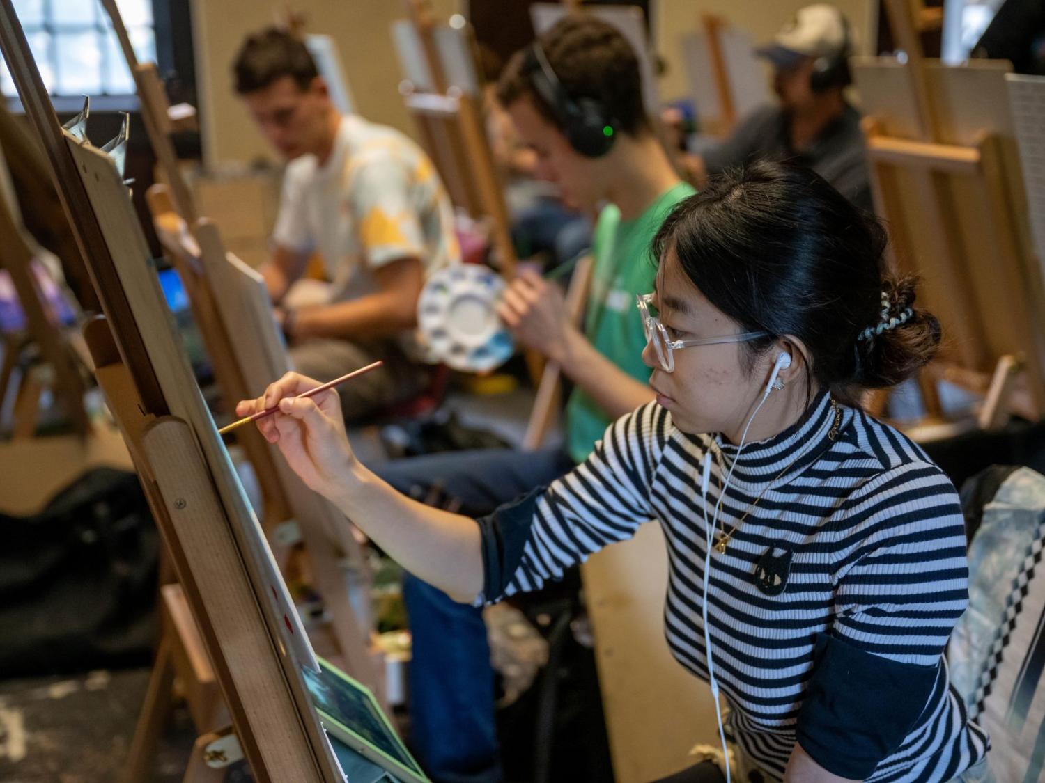 A student paints in an art class at Penn State Behrend