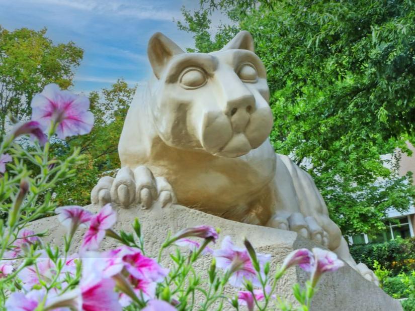 Penn State Berks Lion Shrine with summer flowers around it