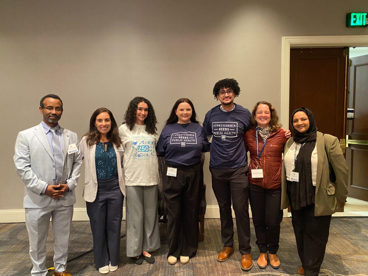Adane Kebede Tesega, PhD, and Penn State public health sciences graduate students and faculty pose together at the Public Health 250 Symposium in Harrisburg.