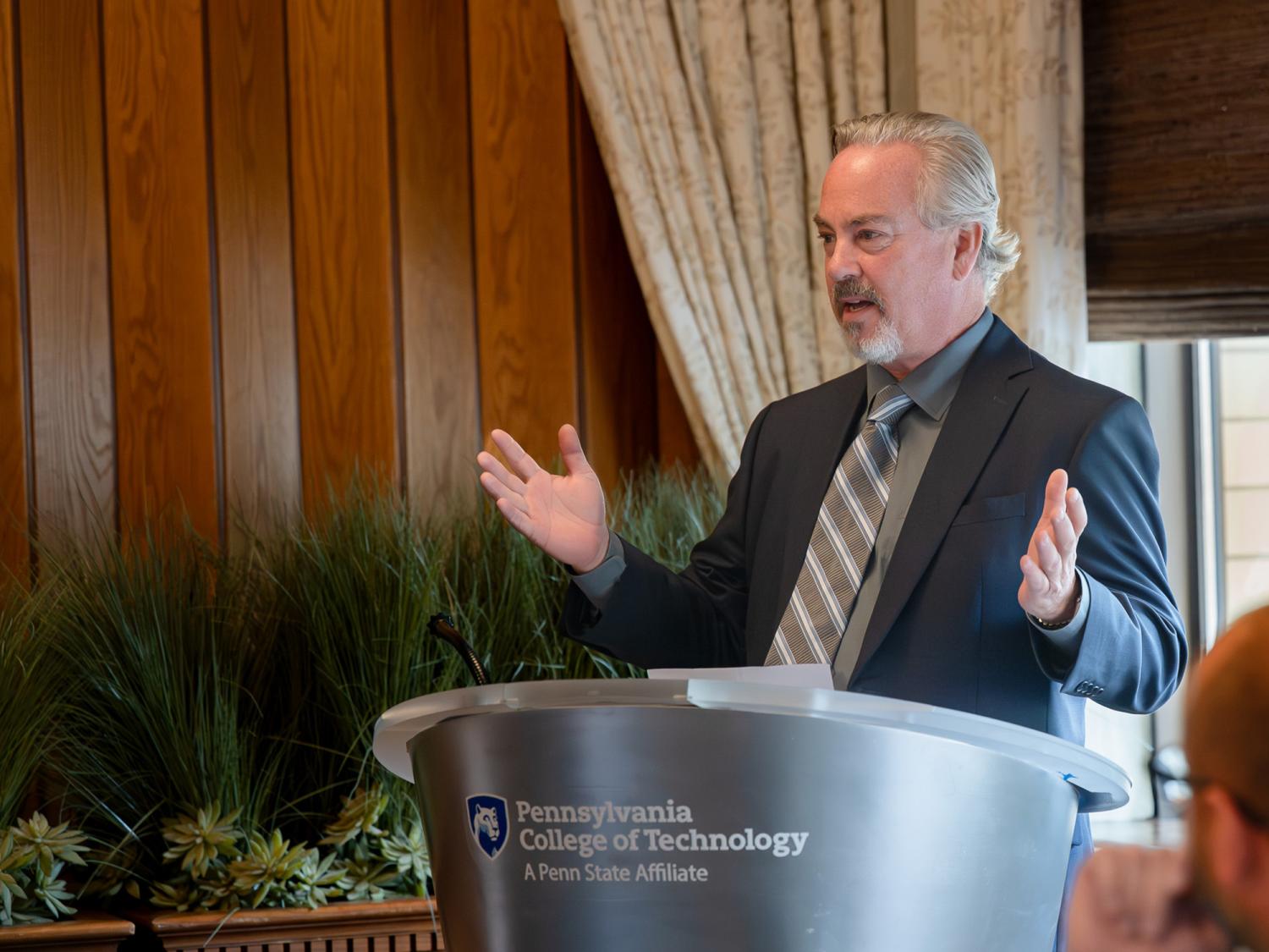 Brook J. Lenfest stands at a podium and speaks during a visit to Pennsylvania College of Technology
