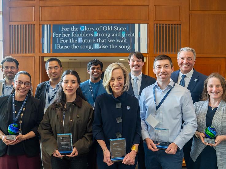 A group of people holding awards