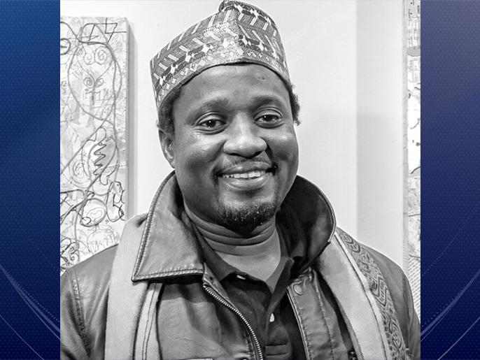 Head shot of a Black man with a goatee smiling
