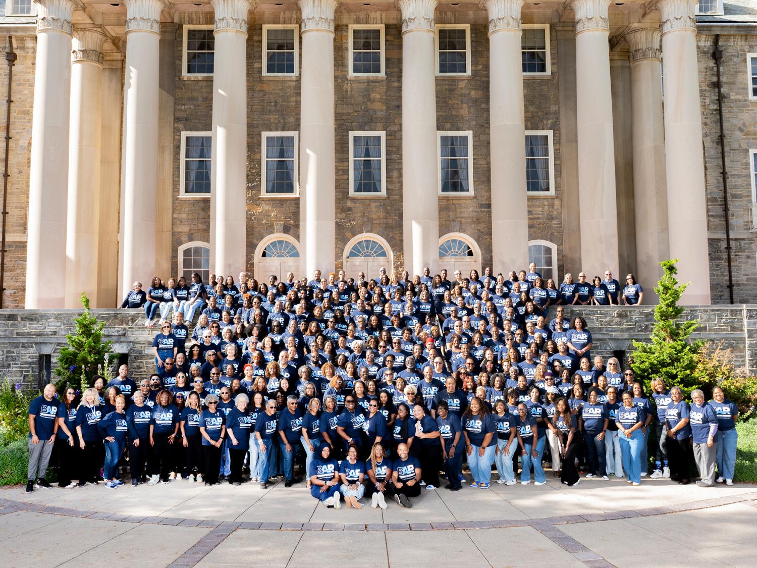Penn State Alumni Association's Black Alumni Reunion attendees sit on the steps of Old Main for a group photo. There are about 350 people in this photo.