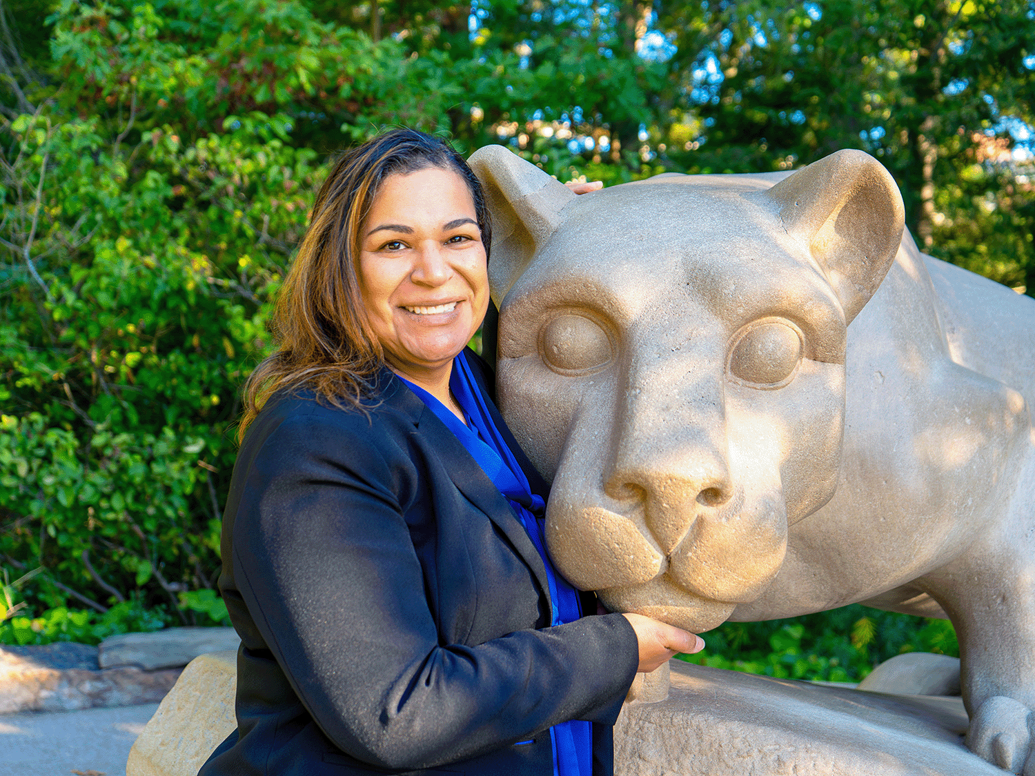 Photo of Minerva Matos-Garner by the University Park Nittany Lion Shrine