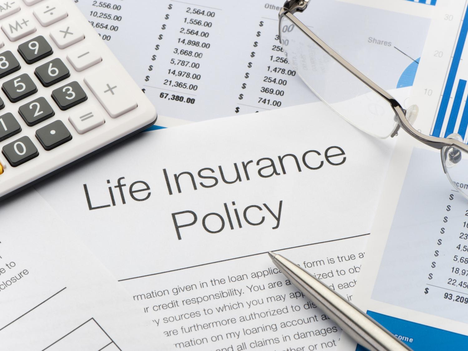 Close up of Life Insurance Policy with pen, calculator