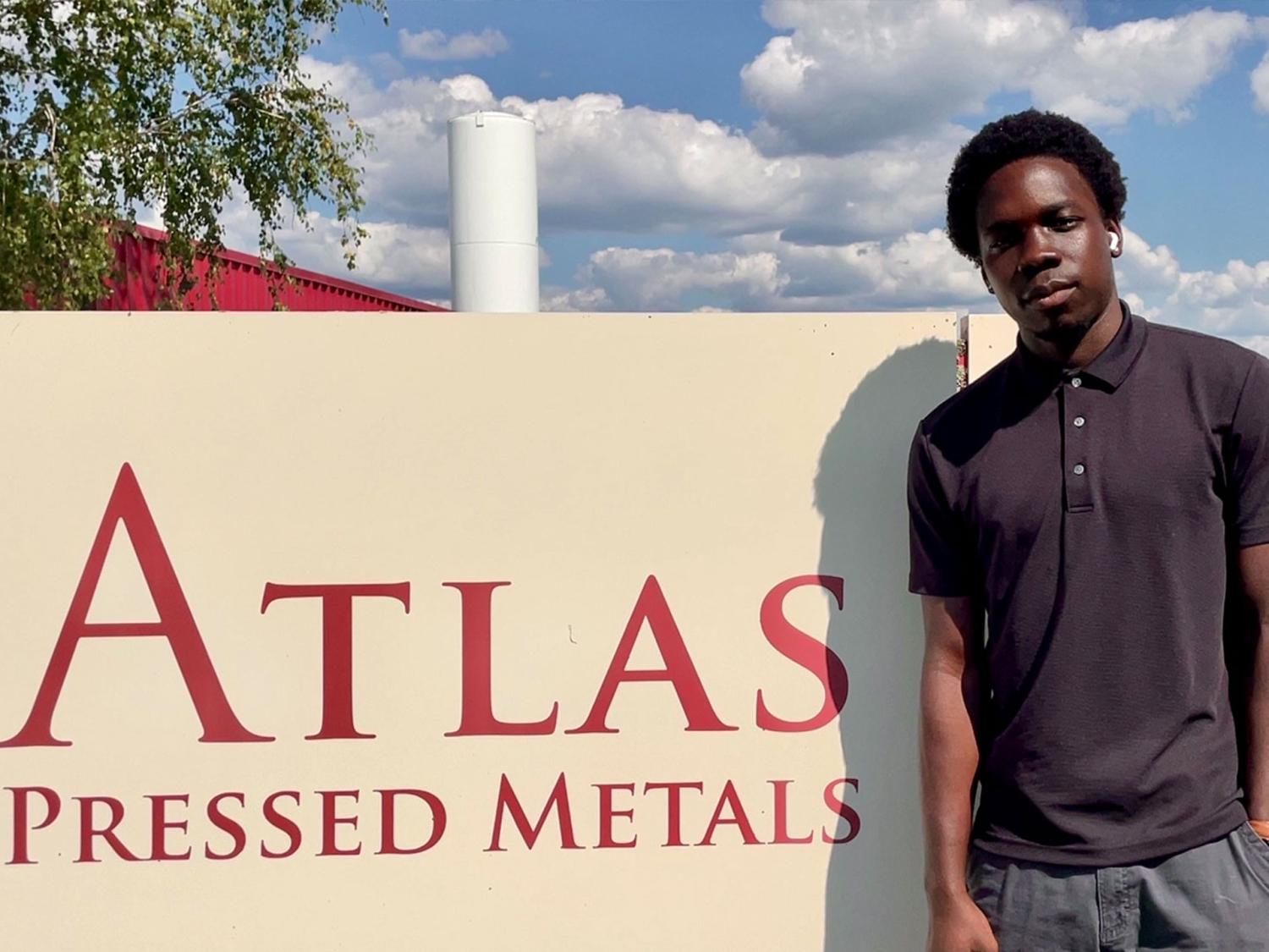 man standing in front of sign