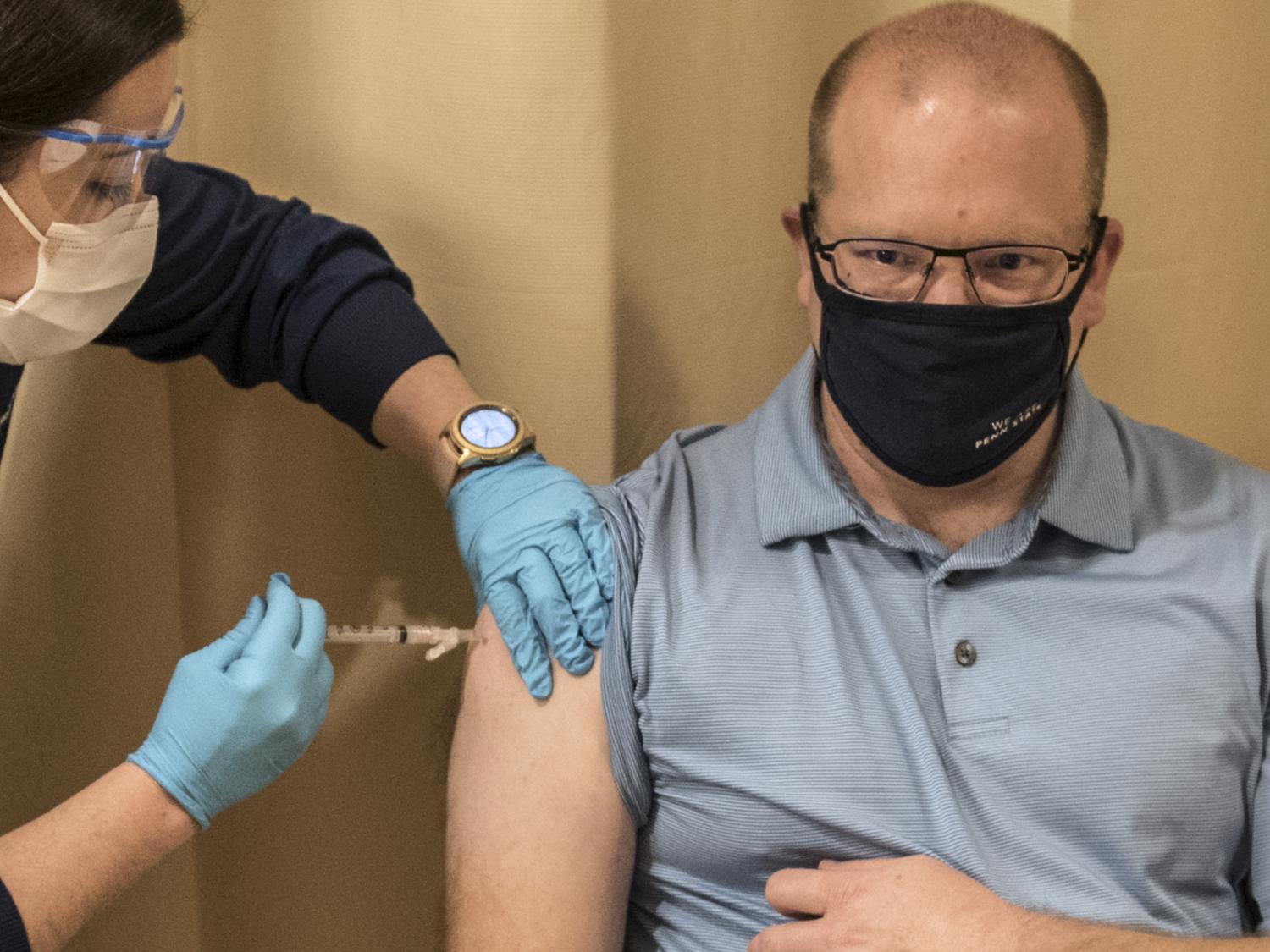Josh Guiher, COVID-19 screening site supervisor at Penn State, receives the COVID-19 vaccine.  