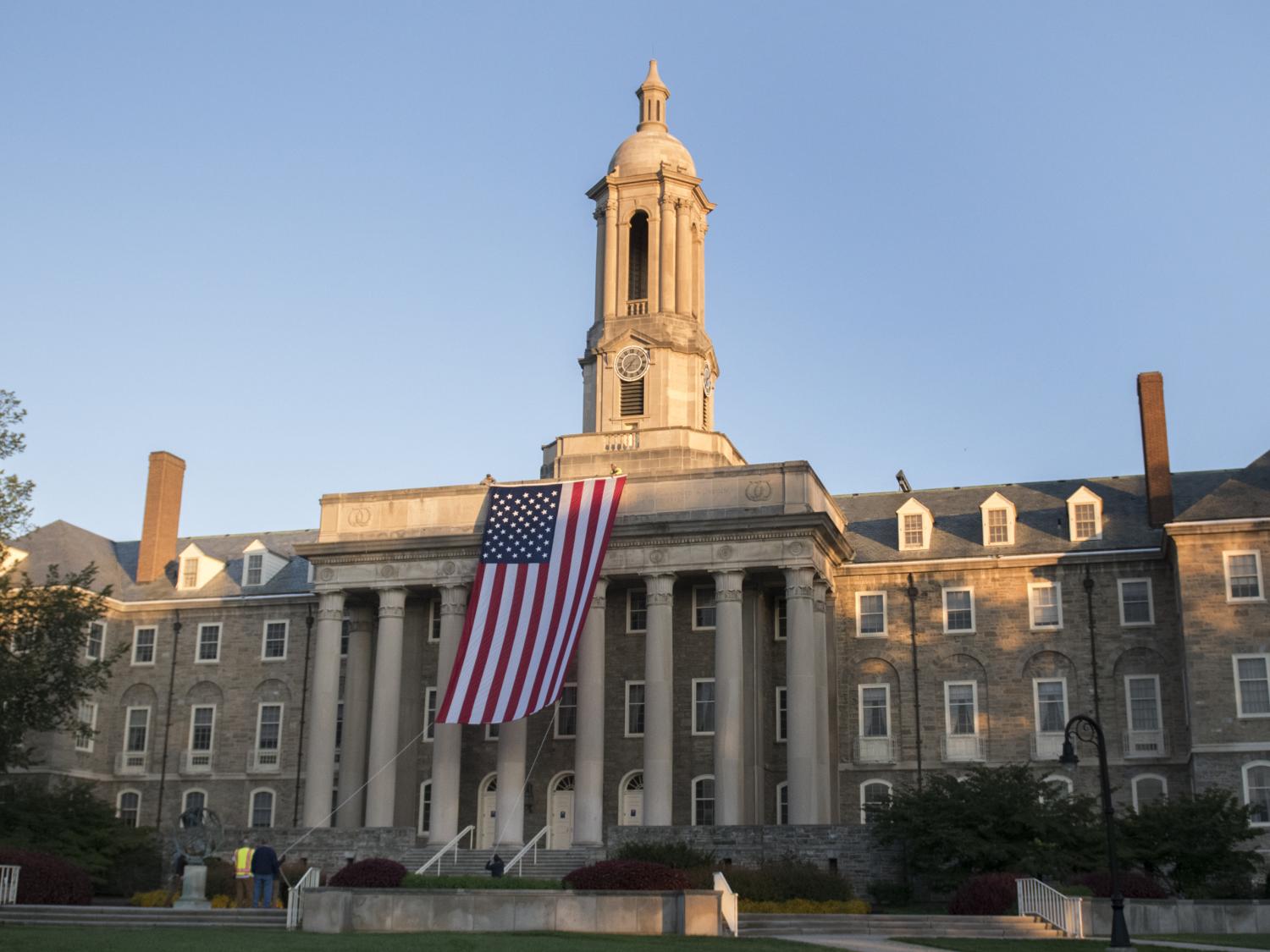 wide shot old main with flag
