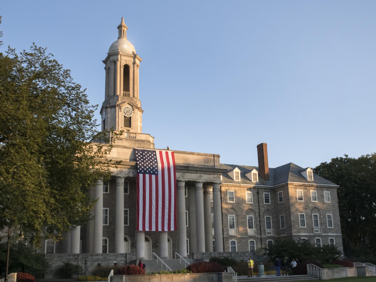USA flag draped from Old Main building