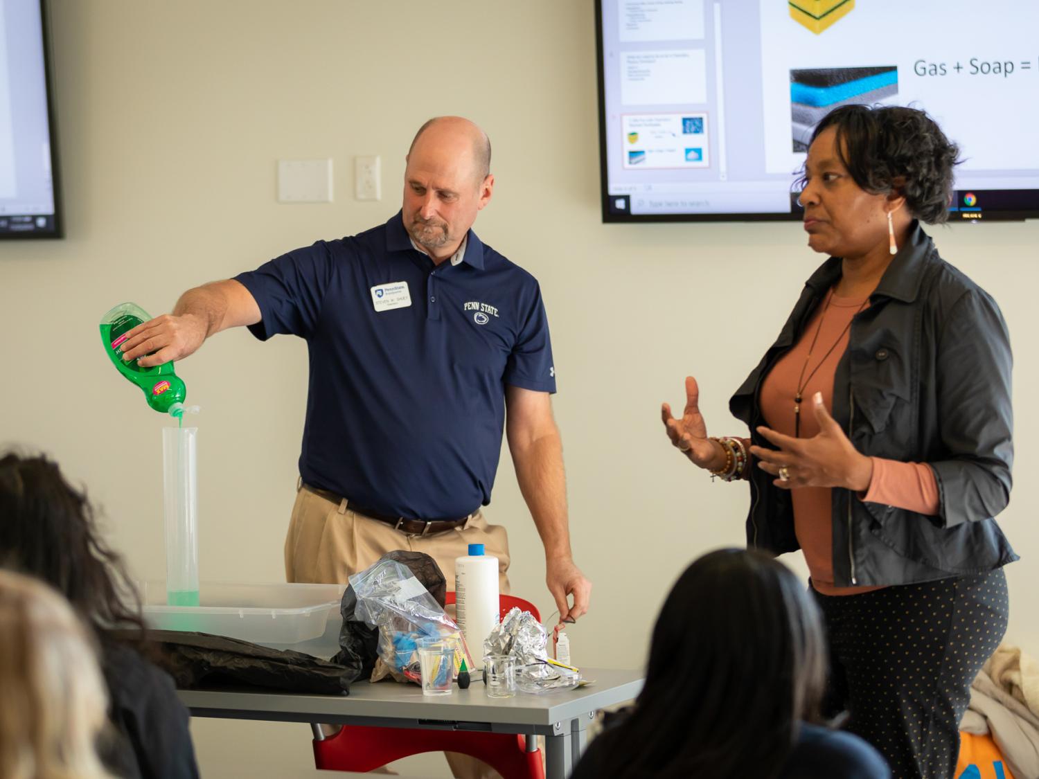 Penn State Brandywine faculty conduct a chemistry experiment for high school girls.