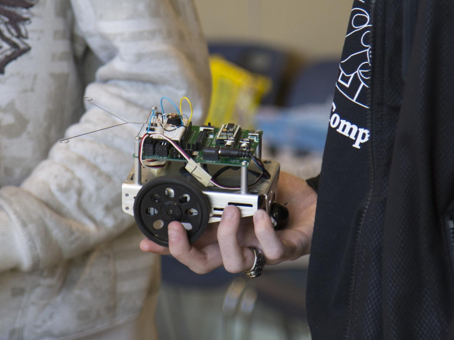 student holding robot