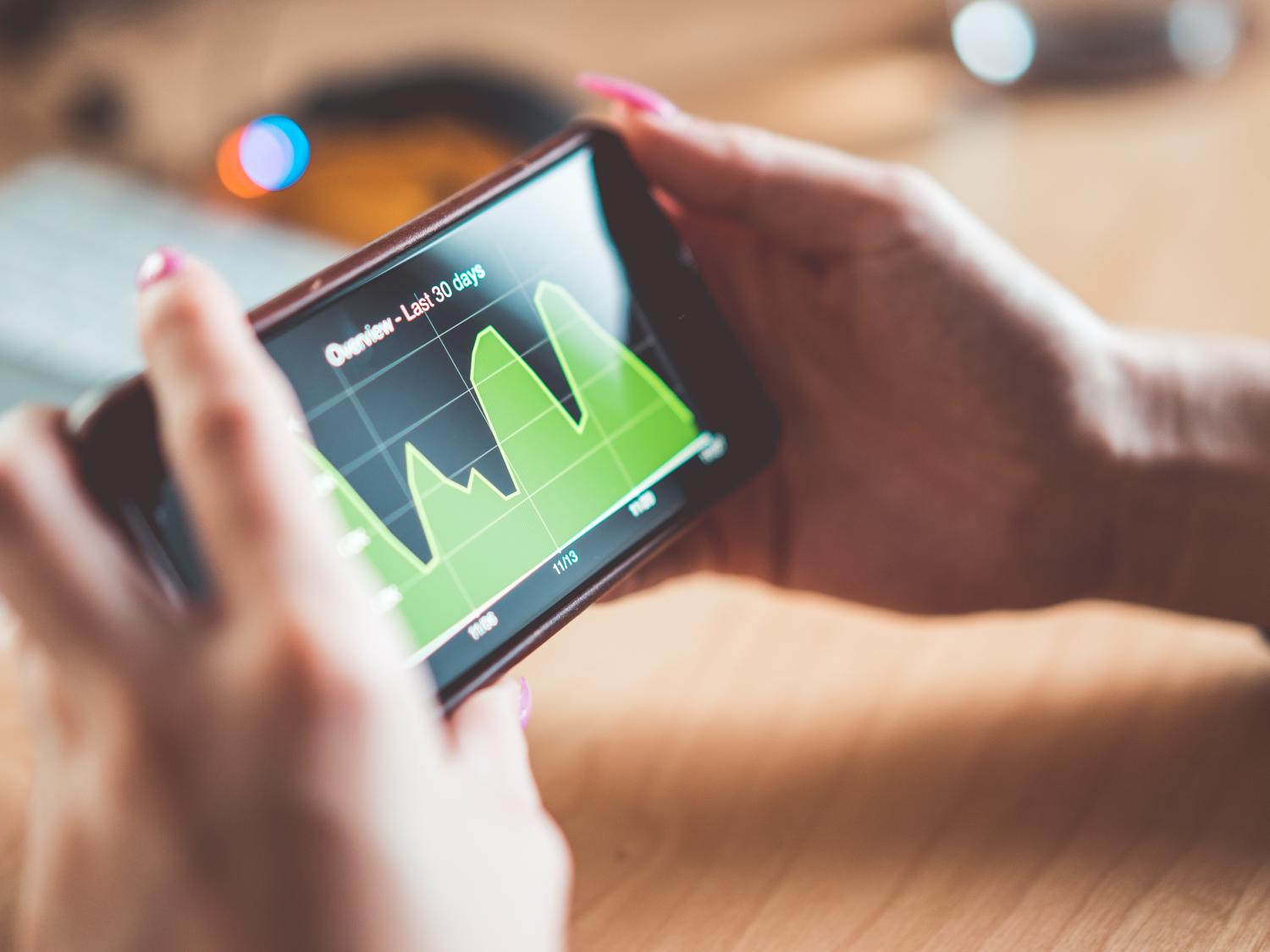 Woman analyzing website traffic on iPhone