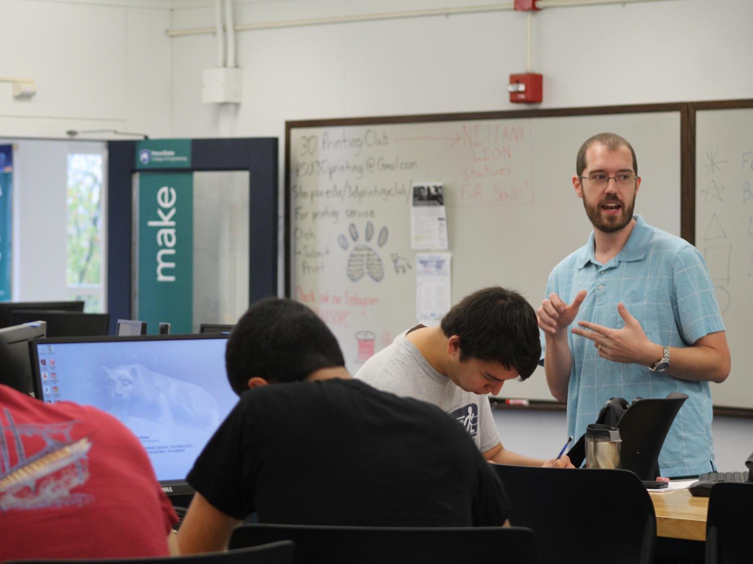Professor in front of the class talking to students 