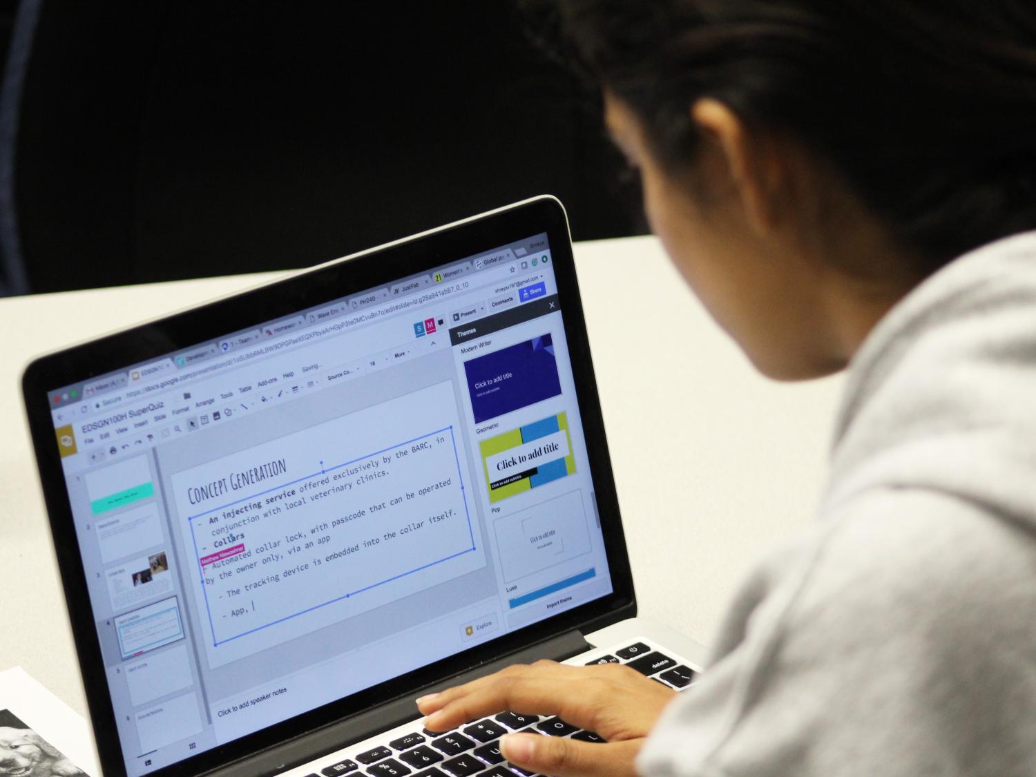 Female student working to complete a concept generation slide for a presentation 
