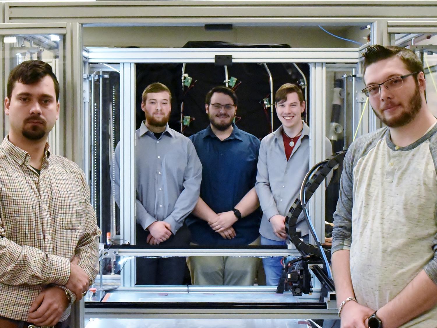 John Nowakowski, far left, Ryan Hutchinson, Michael Gibilterra, Elijah Thompson and Mike Paul worked together to build a large-format 3D printer from scratch in Penn State Behrend's Innovation Commons.