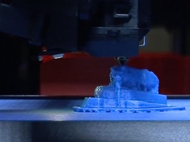 3-D printer head finishing print of blue Nittany Lion shrine 
