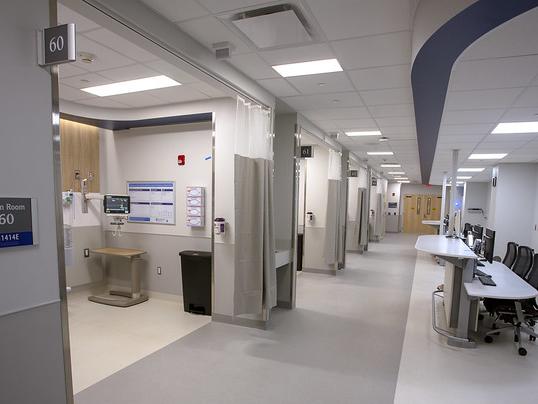 An empty hospital wing with four exam rooms.