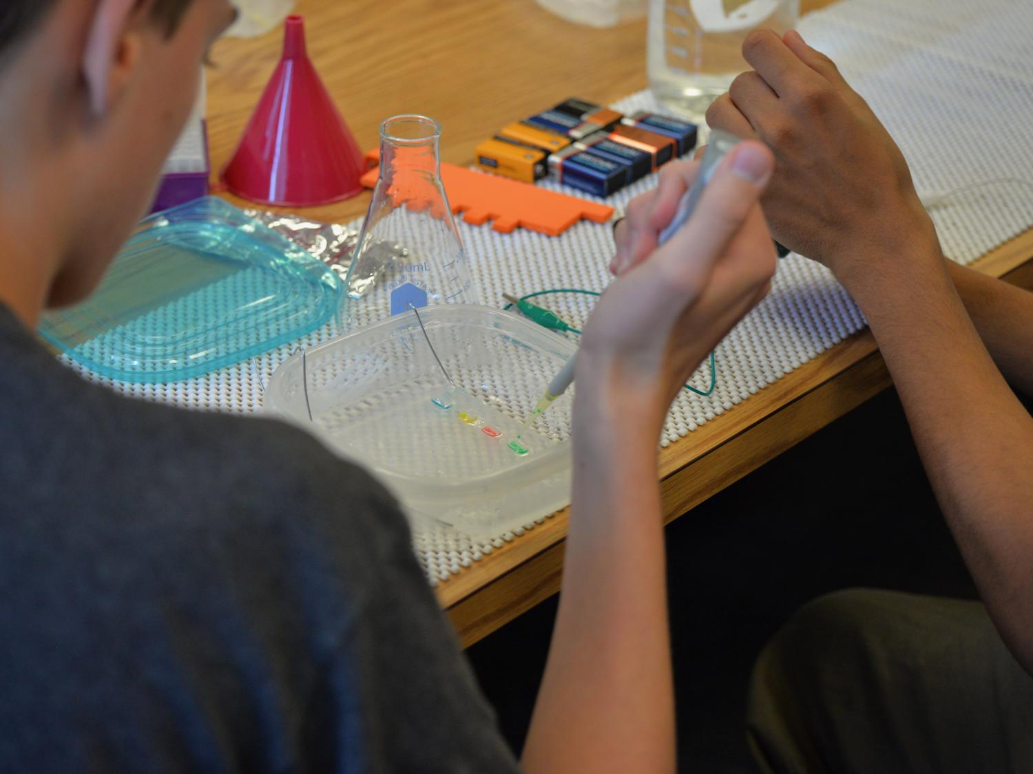 two students working on science project