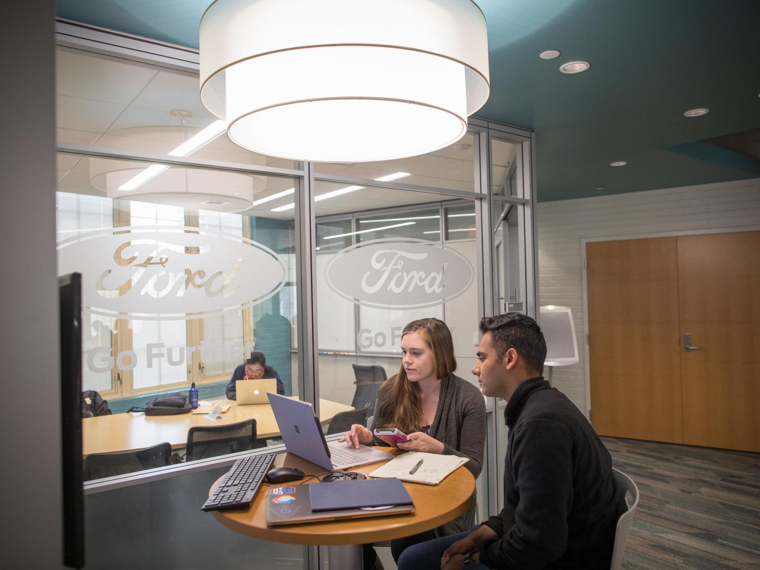 Two students work on a computer in the Penn State Gurshaney Family E-Knowledge Commons. 