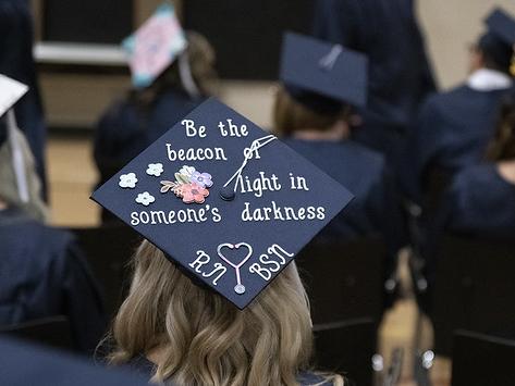 A 2019 Penn State Fayette graduate's cap reads "Be the beacon of light in someone's darkness."