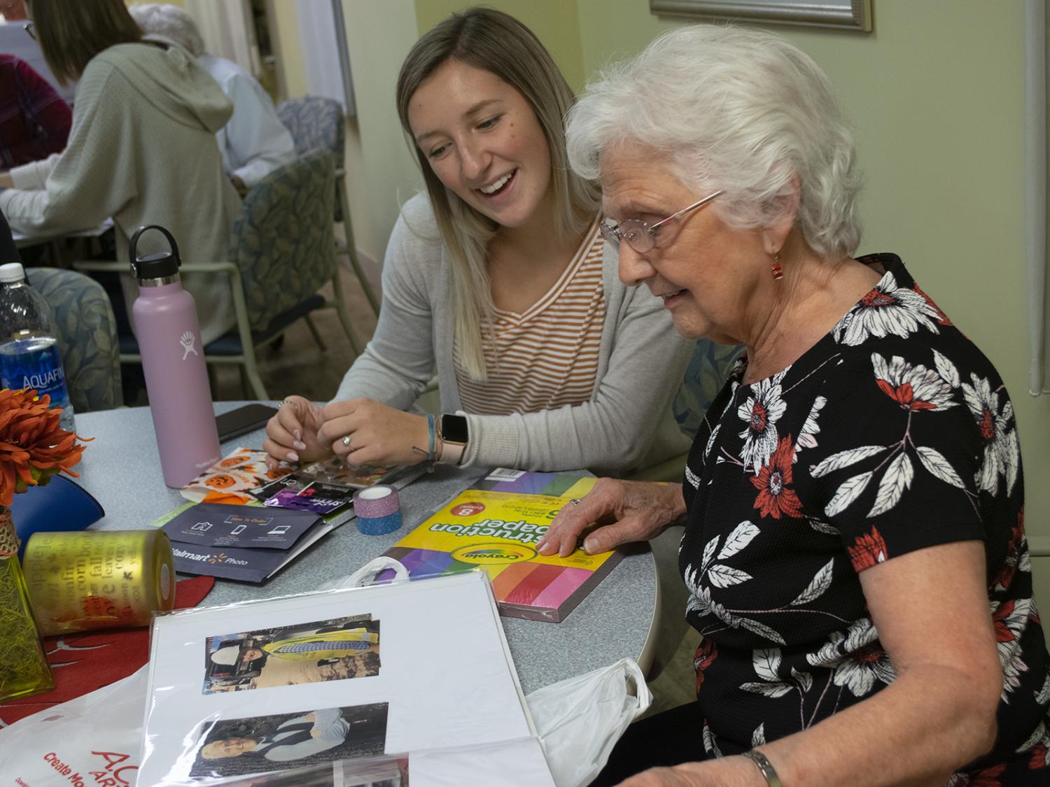 younger woman sitting with older woman