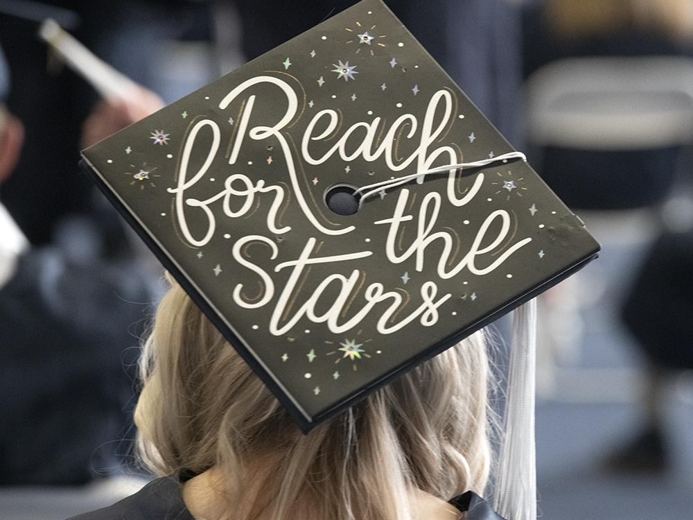 A graduate's cap reads "Reach for the stars"