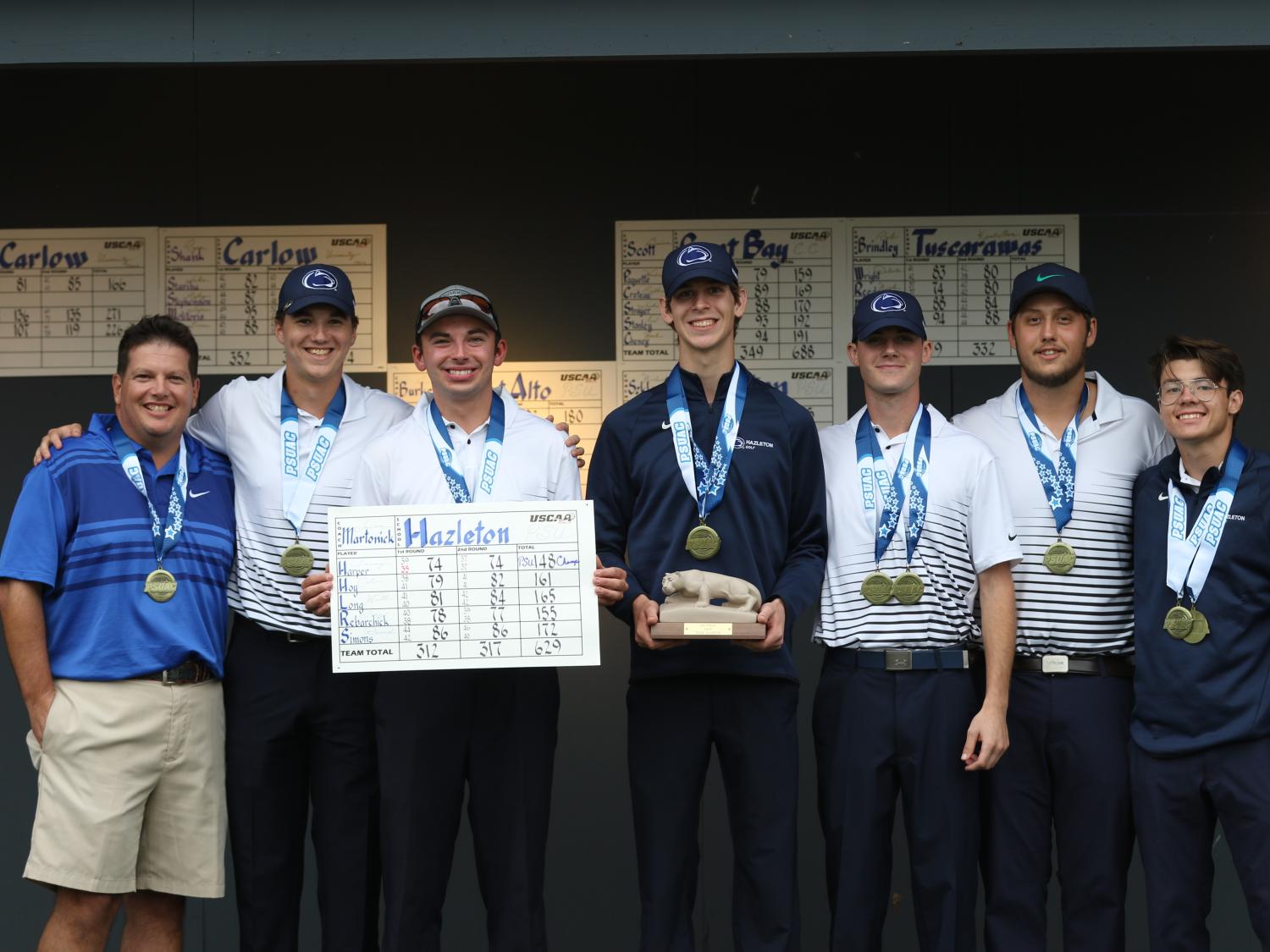 Group of golfers standing in a row wearing medals.