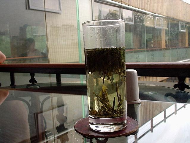 glass of green tea brewing