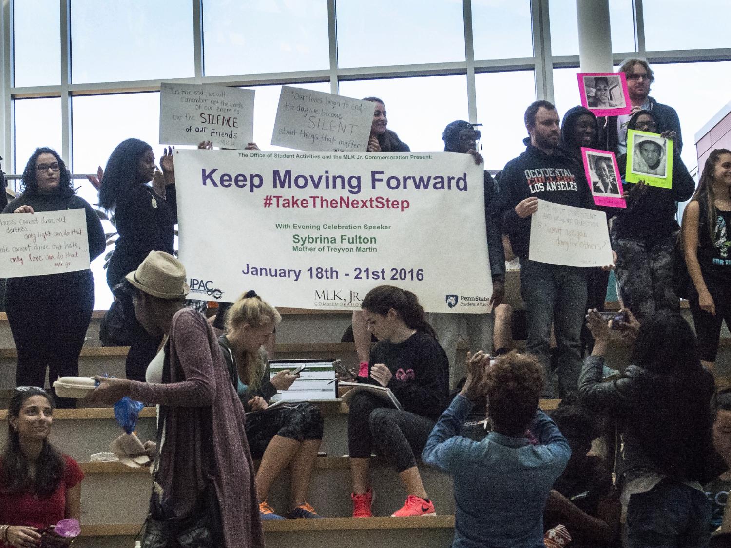 Students holding a banner announcing the theme