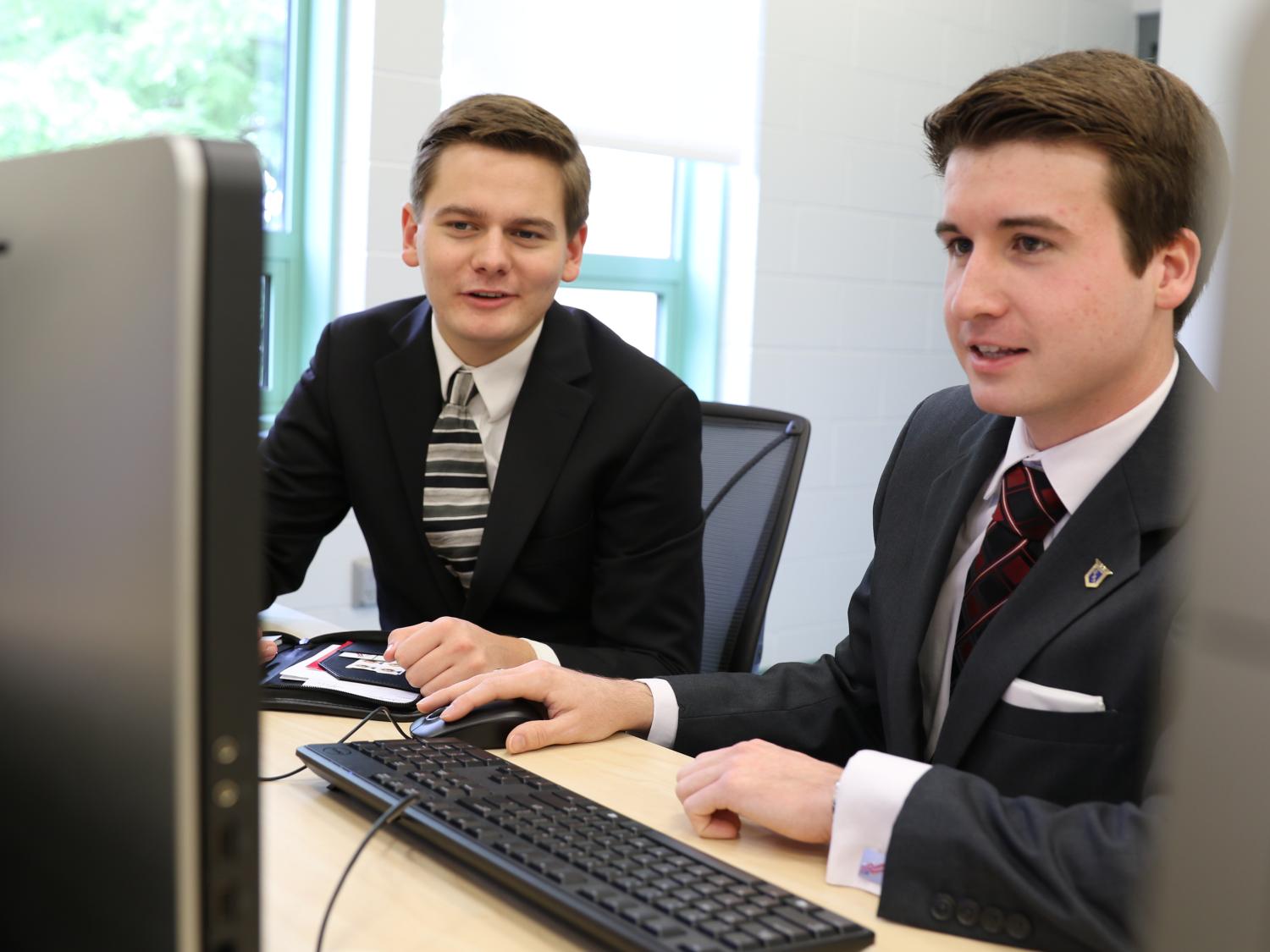 Students Coleman Hart and David Spencer compete at computer.