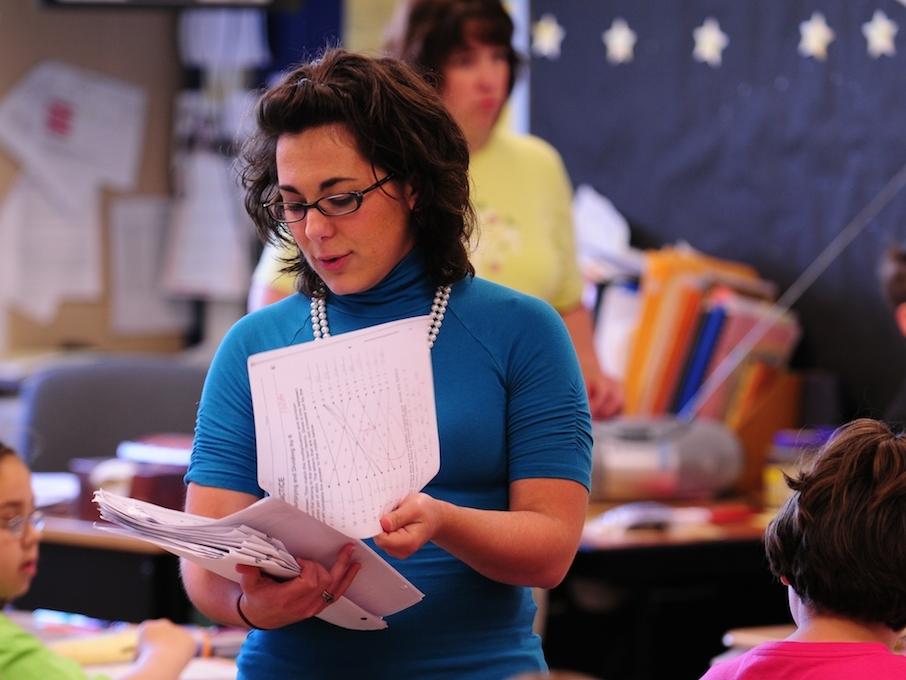 Teacher reviewing papers